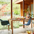 The evergreen shell Eames Molded Plastic Armchair Wire Base from Herman Miller in a dining room.