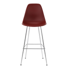 The brick red shell Eames Molded Plastic Bar Height Stool from Herman Miller with the trivalent chrome base.