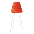 The red orange shell Eames Molded Plastic Bar Height Stool from Herman Miller with the white base.