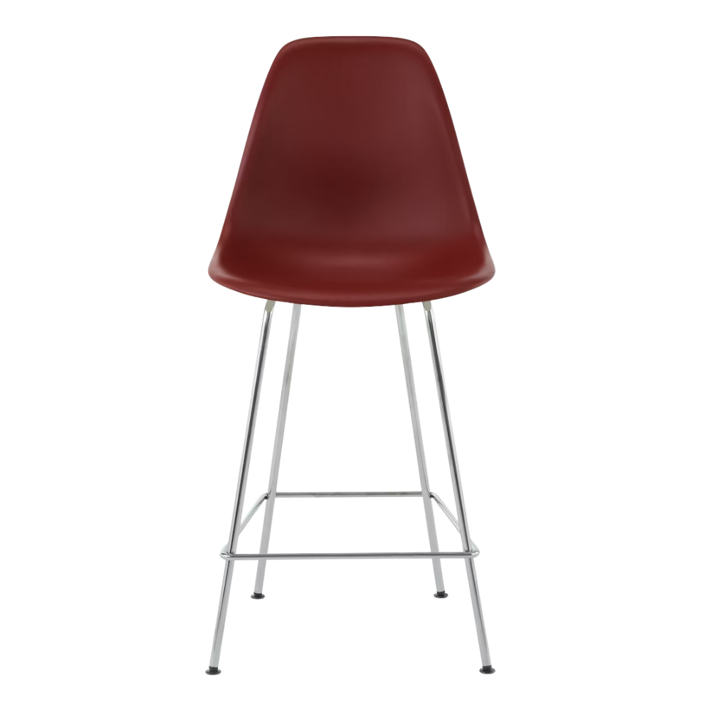 The brick red shell Eames Molded Plastic Counter Height Stool from Herman Miller with the trivalent chrome base.
