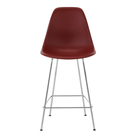 The brick red shell Eames Molded Plastic Counter Height Stool from Herman Miller with the trivalent chrome base.