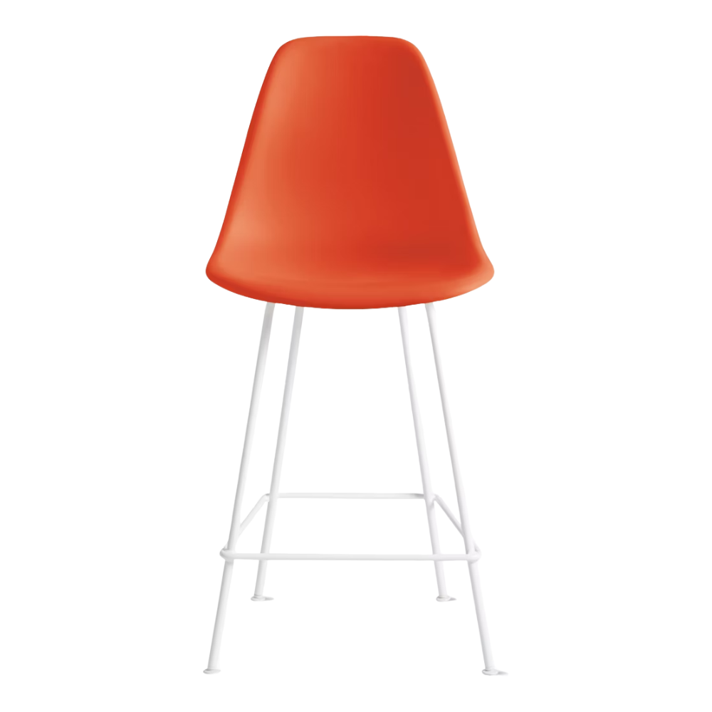 The red orange shell Eames Molded Plastic Counter Height Stool from Herman Miller with the white base.