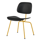 The Eames Molded Plastic Dining Chair from Herman Miller with the black shell and marigold leg finish.