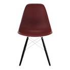 The brick red shell Eames Molded Plastic Side Chair Dowel-Leg Base from Herman Miller with the white base and ebony legs.