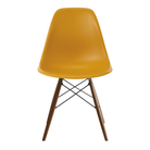 The deep yellow shell Eames Molded Plastic Side Chair Dowel-Leg Base from Herman Miller with the black base and walnut legs.