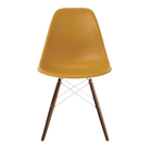 The deep yellow shell Eames Molded Plastic Side Chair Dowel-Leg Base from Herman Miller with the white base and walnut legs.