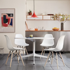 The white shell Eames Molded Plastic Side Chair Dowel-Leg Base from Herman Miller in a family area.