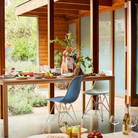 The blue green shell Eames Molded Plastic Side Chair Wire Base from Herman Miller in a family area.