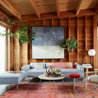 The Eames Molded Plywood Coffee Table Metal Base from Herman Miller in a living room. all-groups