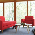The white ash Eames Molded Plywood Coffee Table from Herman Miller in a living room. all-groups