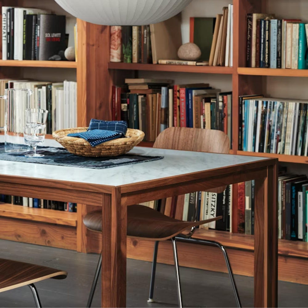 The Eames Molded Plywood Dining Chair Metal Base from Herman Miller in a home office. all-groups