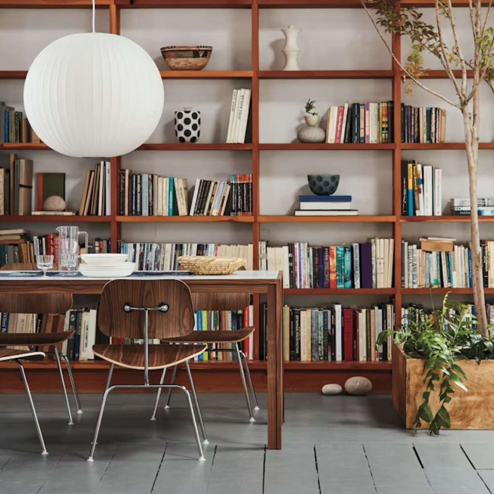 The Eames Molded Plywood Dining Chair Metal Base from Herman Miller in the lounge of a library. all-groups