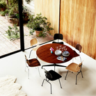 The Eames Molded Plywood Dining Chair Metal Base from Herman Miller in a living room. all-groups