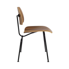 The side of the Eames Molded Plywood Dining Chair Metal Base from Herman Miller with the walnut shell and black legs.