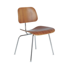 The Eames Molded Plywood Dining Chair Metal Base from Herman Miller with the walnut shell and trivalent chrome legs from an angle.