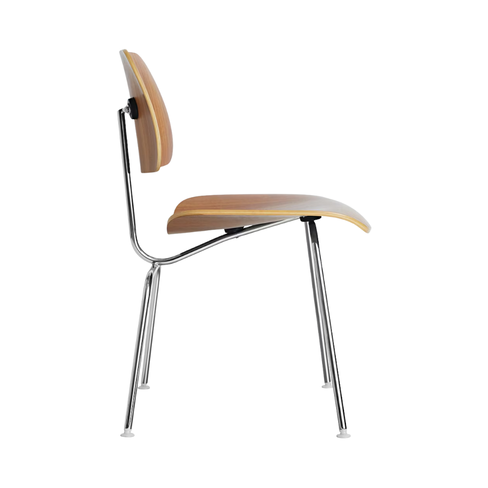The side of the Eames Molded Plywood Dining Chair Metal Base from Herman Miller with the walnut shell and trivalent chrome legs.