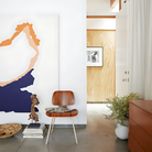 The santos palisander Eames Molded Plywood Dining Chair Wood Base from Herman Miller in a living room.