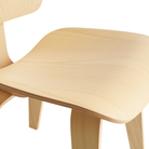 The white ash Eames Molded Plywood Dining Chair Wood Base from Herman Miller focusing on the seat.