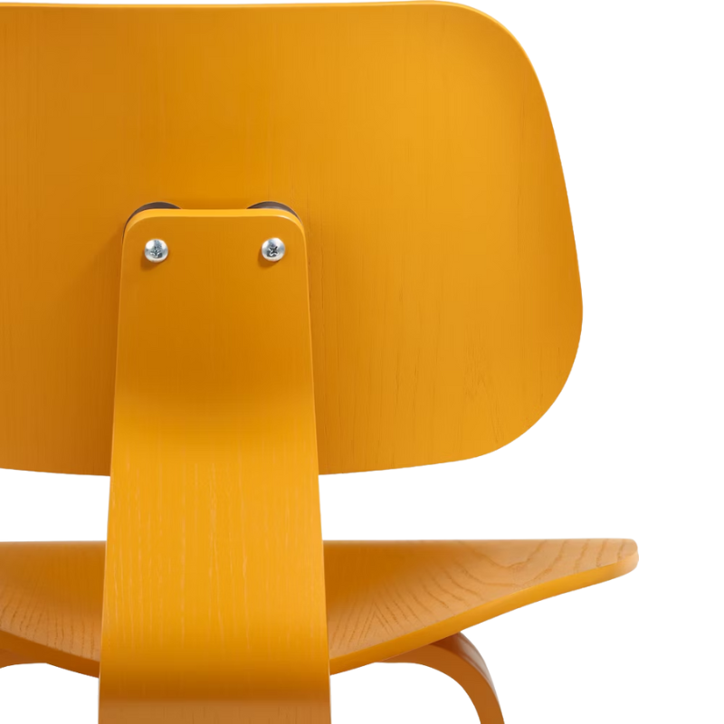 The Deep Yellow Stain Eames Molded Plywood Lounge Chair Wood Base from Herman Miller close up.