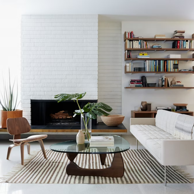 The Santos Palisander Eames Molded Plywood Lounge Chair Wood Base from Herman Miller in a family space.
