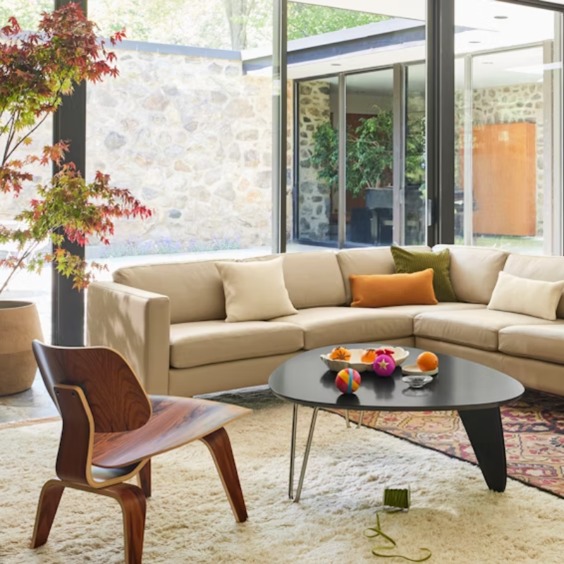 The Santos Palisander Eames Molded Plywood Lounge Chair Wood Base from Herman Miller in a lounge.