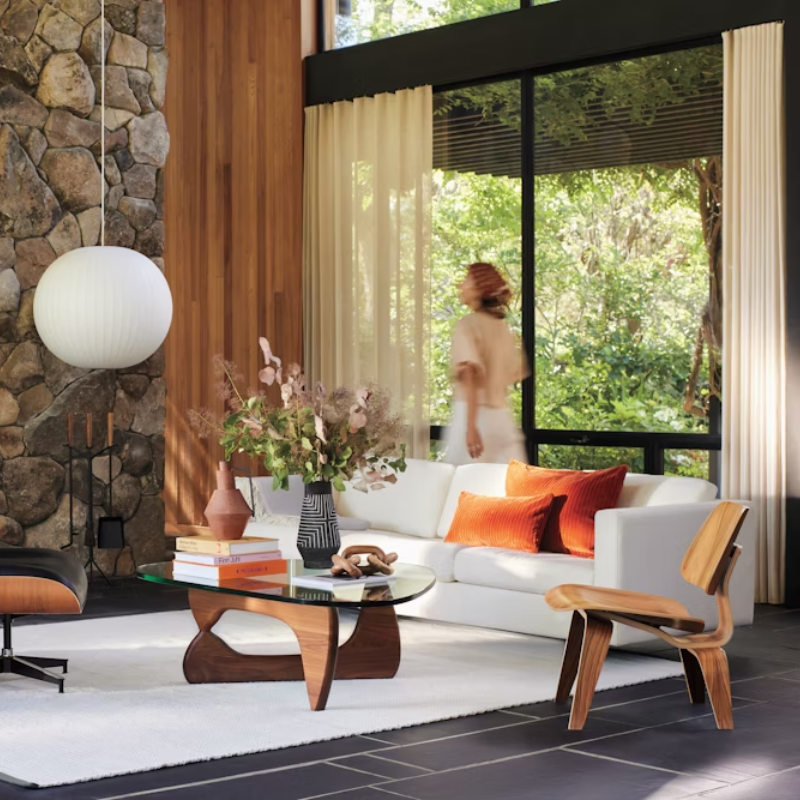 The Walnut Eames Molded Plywood Lounge Chair Wood Base from Herman Miller in a home office.