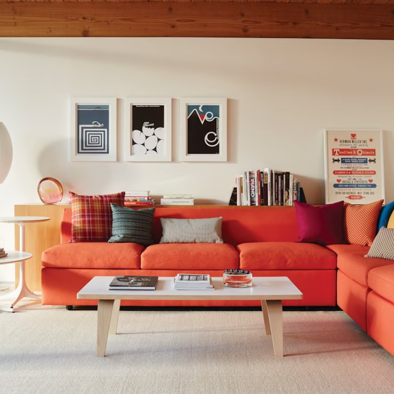 The studio white and ash laminate Eames Rectangular Coffee Table in a living room.