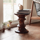 The Eames Turned Stool from Herman Miller in a bedroom.