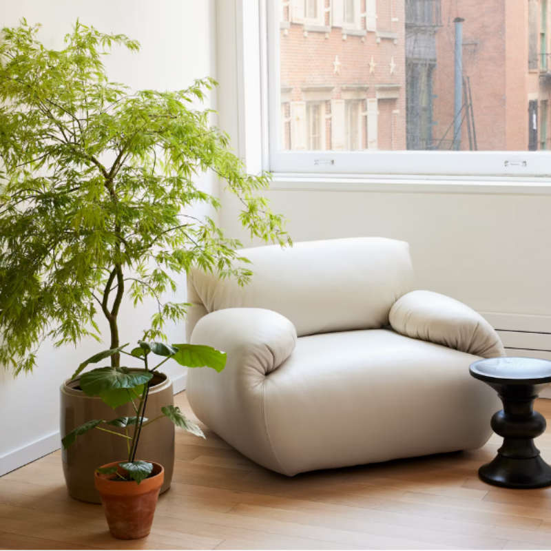 The Eames Turned Stool from Herman Miller in a den.