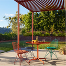 The Eames Wire Chair from Herman Miller, designed by Herman Miller x HAY in an outdoor dining set up. all-groups.