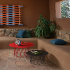 The anthracite and vivid red Girard Flower Table from Herman Miller in a lounge. all-groups