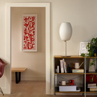 The Nelson Cigar Lotus Table Lamp from Herman Miller in a living room lifestyle photograph.