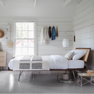 The Nelson Cigar Wall Sconce from Herman Miller in a bedroom.