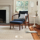 The Nelson Cigar Wall Sconce from Herman Miller in a living room.