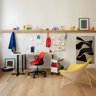 The Nelson Coconut Chair from Herman Miller with the goldenrod mode upholstery and white base in a workspace.