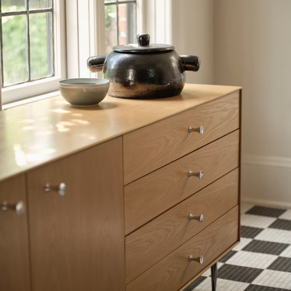 The Nelson Thin Edge Buffet from Herman Miller in white oak with a pot on top.