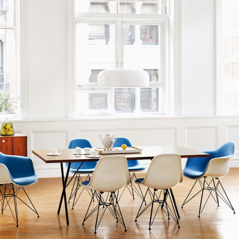 The walnut and black Nelson X-Leg Table from Herman Miller in a dining room.