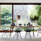 The walnut and black Nelson X-Leg Table from Herman Miller in a family area.