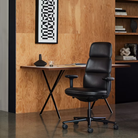 The walnut and black Nelson X-Leg Table from Herman Miller in a home office.