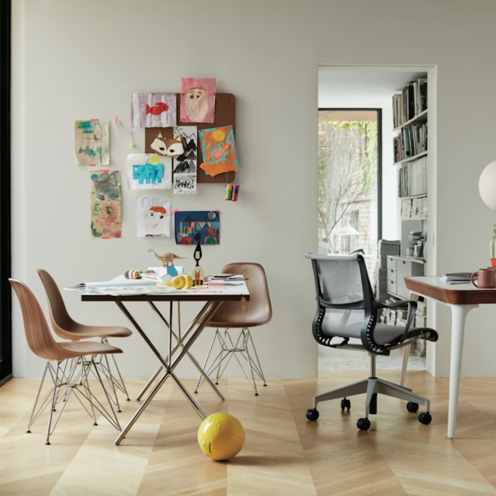 The walnut and chrome Nelson X-Leg Table from Herman Miller in a family area.