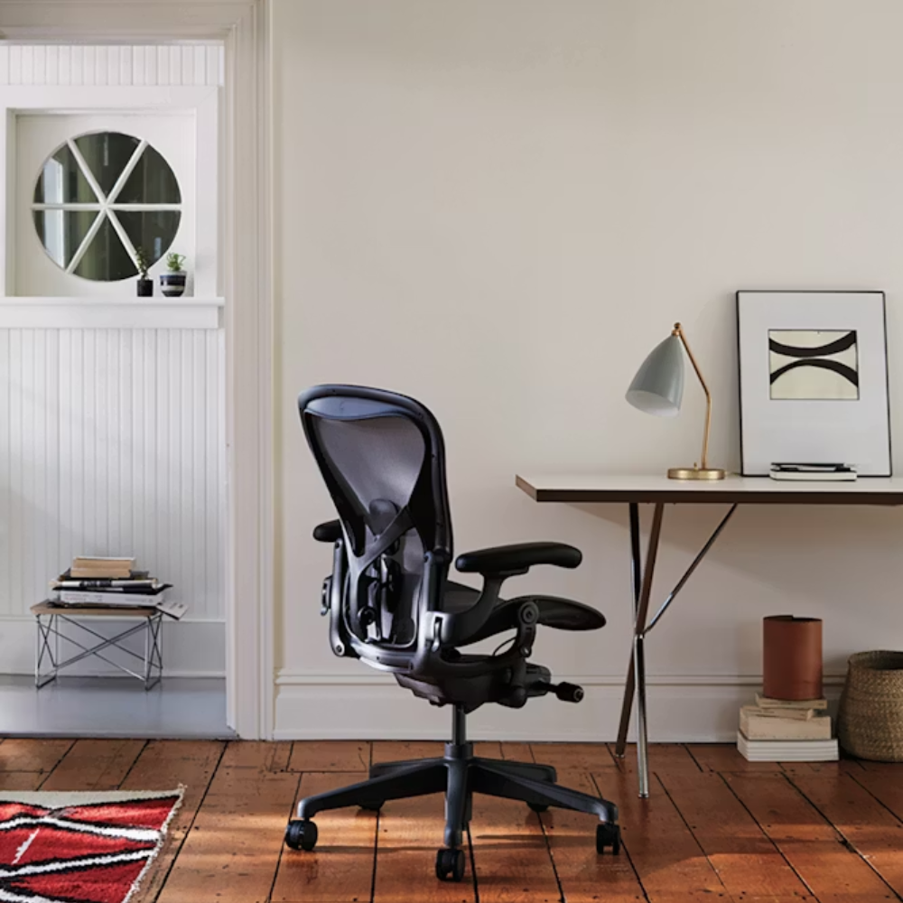 The walnut and chrome Nelson X-Leg Table from Herman Miller in a workspace.