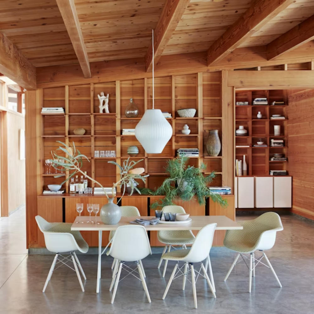 The white Nelson X-Leg Table from Herman Miller in a dining area.