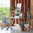 The white Nelson X-Leg Table from Herman Miller in a workspace.