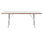 The 36 by 72 inch white Nelson X-Leg Table from Herman Miller from the side.