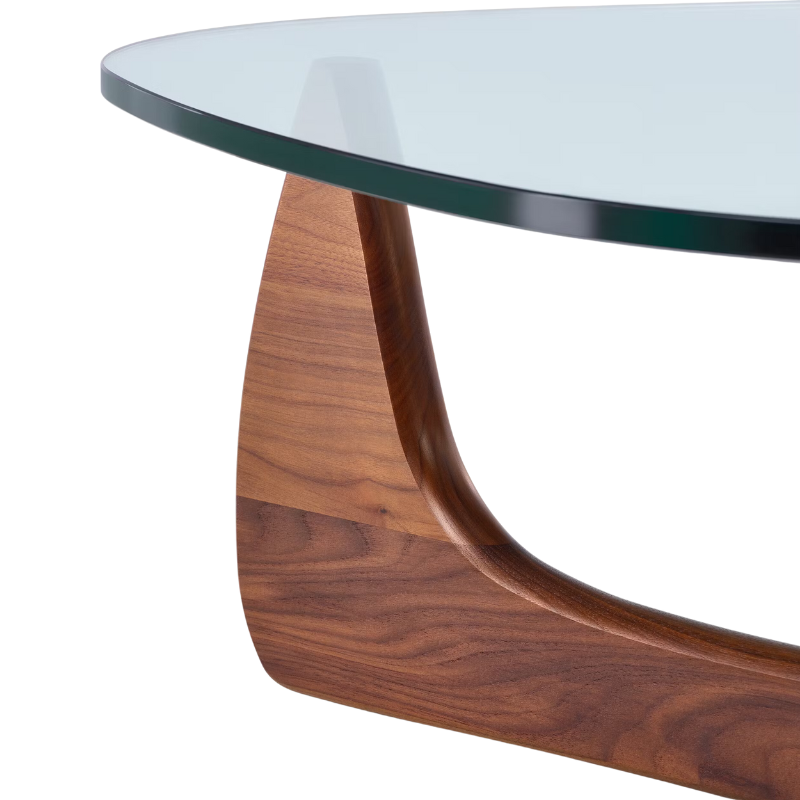 The Noguchi Table from Herman Miller in walnut in a close up shot of the leg.