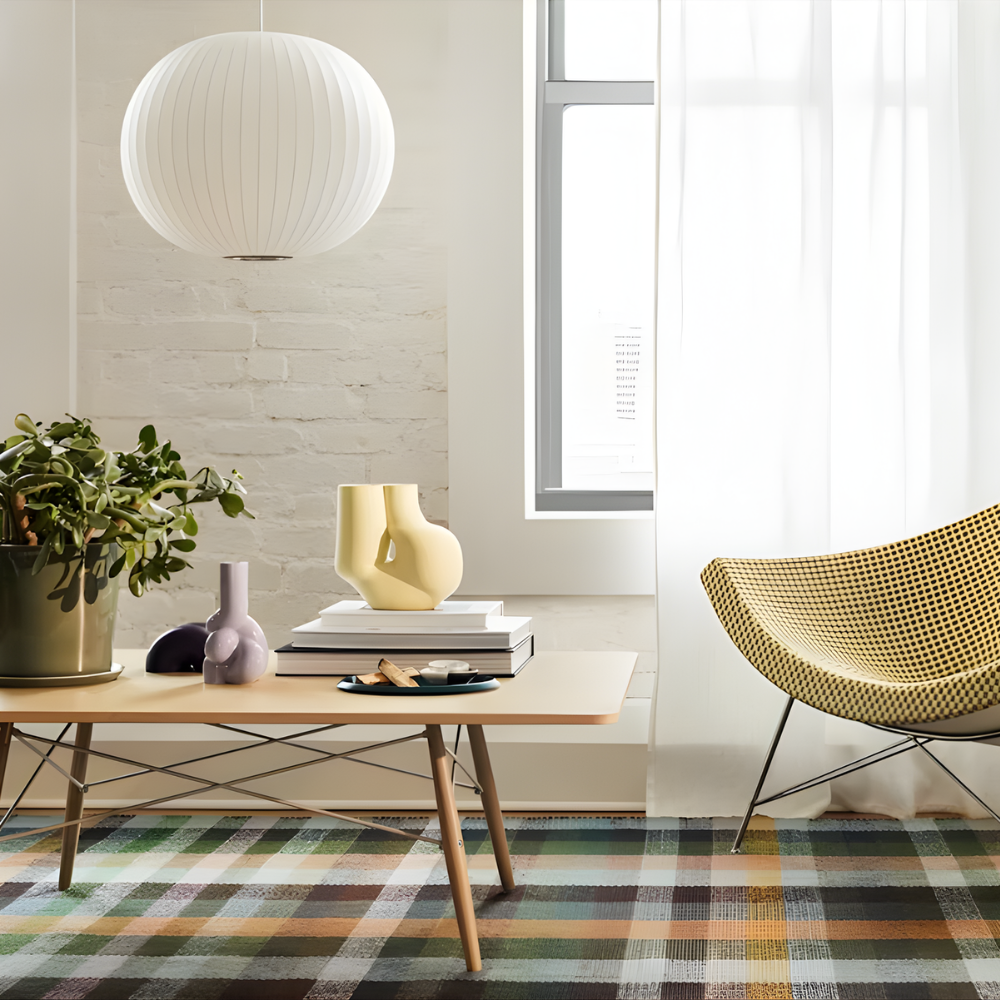 The white ash Rectangular Eames Coffee Table from Herman Miller in a living room. all-groups