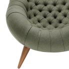 The Rohde Easy Chair from Herman Miller with the agrarian luce upholstery and walnut leg finish showing the base close up.