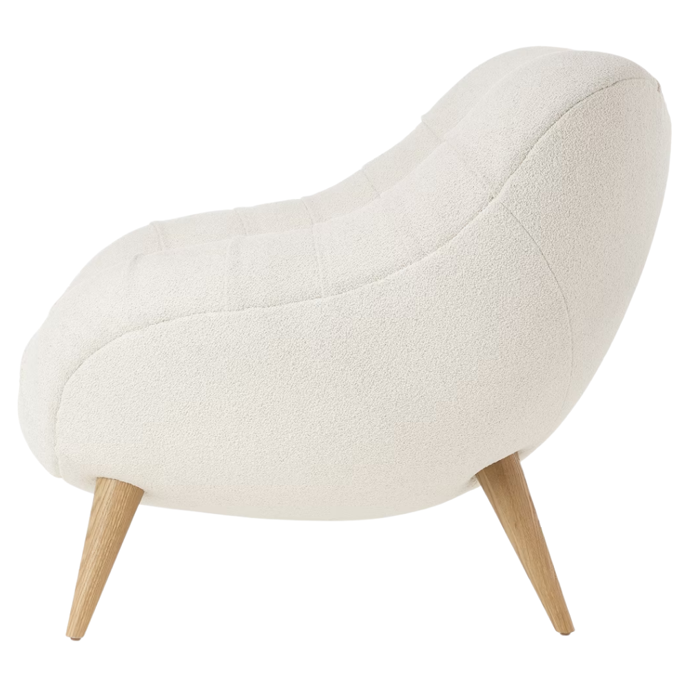 The Rohde Easy Chair from Herman Miller with the warm white whim upholstery and oak leg finish from the side.