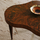 The walnut burl Rohde Paldao Coffee Table from Herman Miller in a family area.