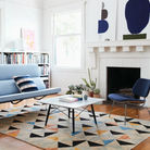 The Square Eames Coffee Table from Herman Miller with the carrara table top and ebony legs in a living room. all-groups